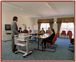 A meeting room with several people im at Whittlebury Hall