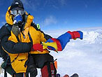 Lorenzo holds up the Tibetan flag on the summit of Everest