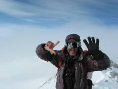 From the summit of Vinson Massif, Lorenzo indicates all seven done
